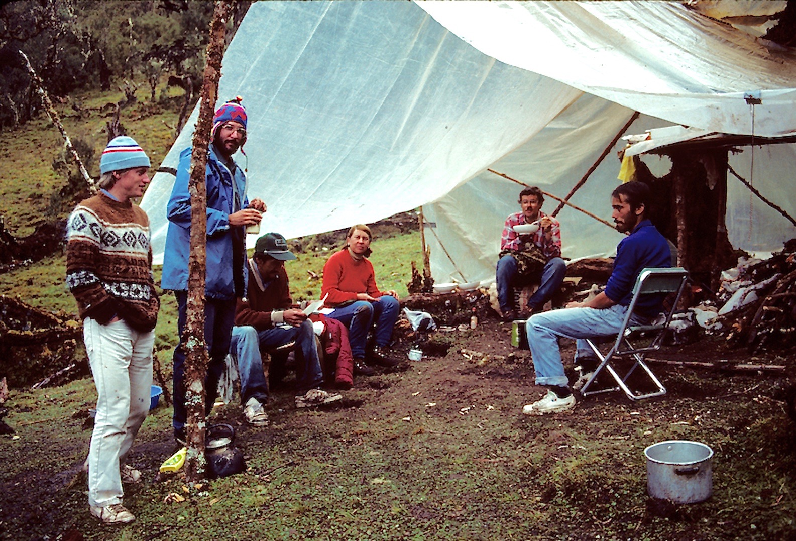 a group of researchers sitting around a campsite