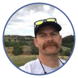 Matt Carling in field wearing baseball hat with sunglasses perched on his head